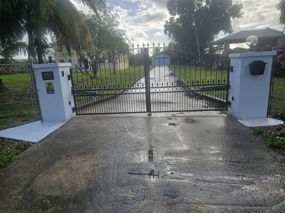 Private gated entrance and driveway leading up to the house